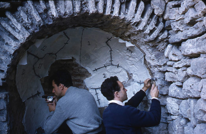 Constantine Tsaousis and Carroll Wales cutting the Japanese mulberry paper and layers of muslin into twelve sections for easier removal of the fresco, 1957